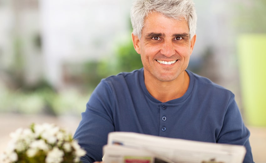 mature man reading newspaper