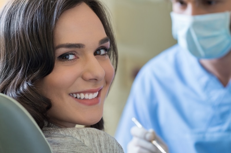 pretty young woman sitting in dental care before a cleaning