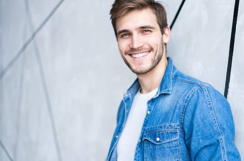 Young man with a handsome smile through the use of Invisalign