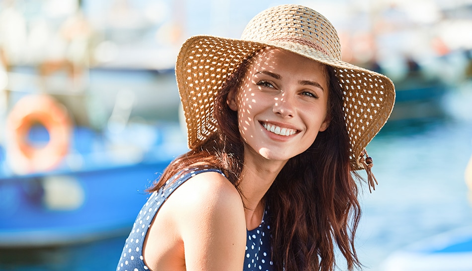 Woman with a beautiful smile wearing a hat