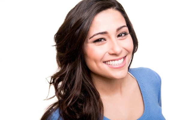 Woman posing Dark haired woman showing off her smile