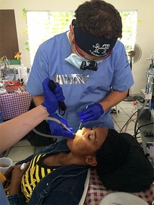 Dr. Taylor Rice working on patient at a free dental care event in Irvine