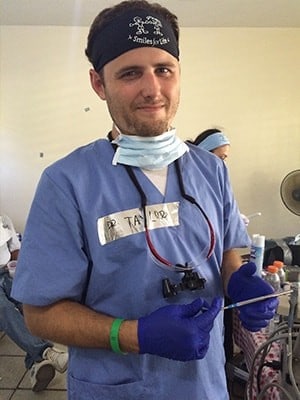 Dr. Taylor Rice working on a dental mission trip where he impacted lives with dentistry