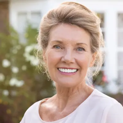 A elderly woman with new dental veneer revisions in Irvine CA