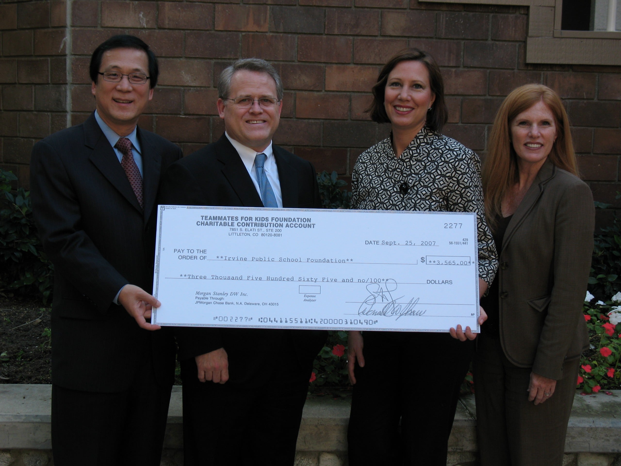 An oversized check from Rice Dentistry to the Irvine Public School Foundation