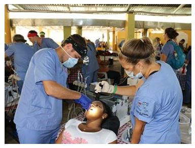 Dr. Taylor Rice of Rice Dentistry works on a patient while serving with Smile for Hope, a charity that provides dental care in remote villages in third word countries-min