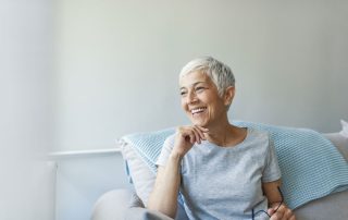 senior woman smiling sitting on couch