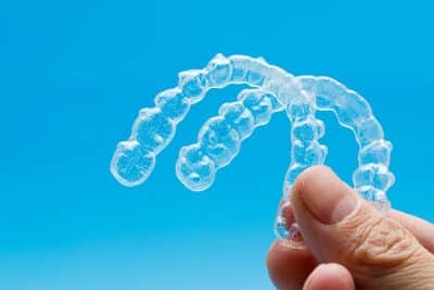 hand holding a set of aligners