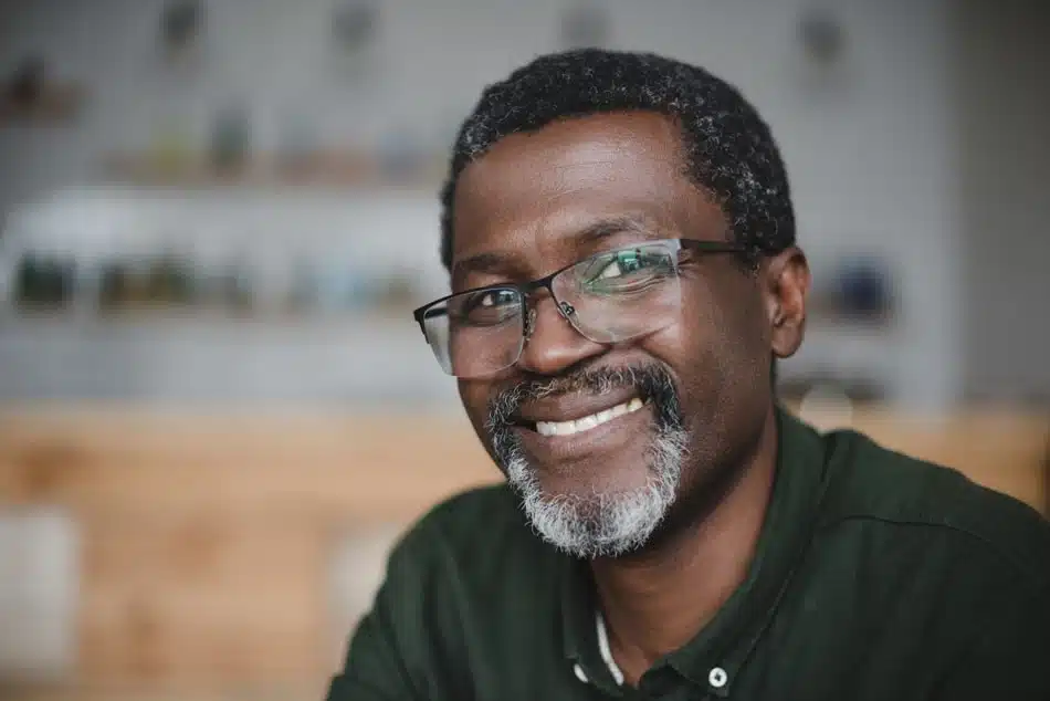 Middle-aged man in glasses looking at camera and smiling
